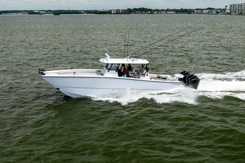 Slide: The Image of 2025 Freeman 42 LR boat cruising on open water with fishing rods. - 19