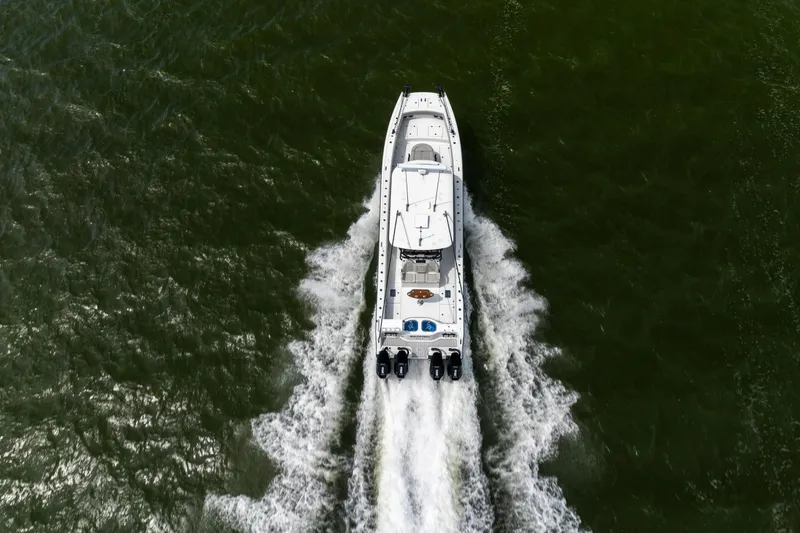 Slide: The Image of Aerial view of 2025 Freeman 42 LR boat cruising on green water. - 21