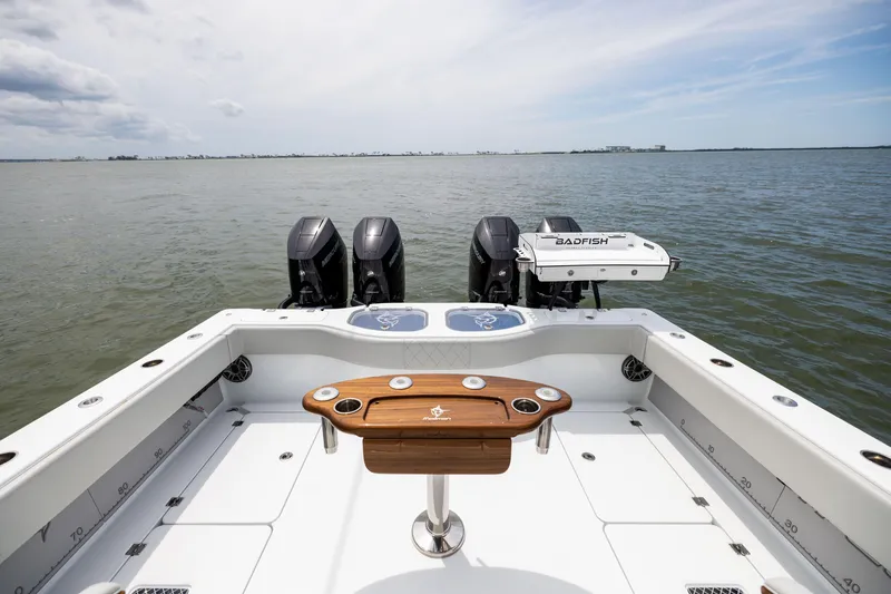 Slide: The Image of Freeman 42 LR 2025 boat with quad engines on open water. - 25