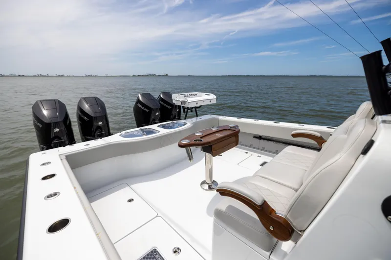 Slide: The Image of Luxury Freeman 42 LR boat interior with seating, table, and multiple outboard motors, 2025 model. - 27