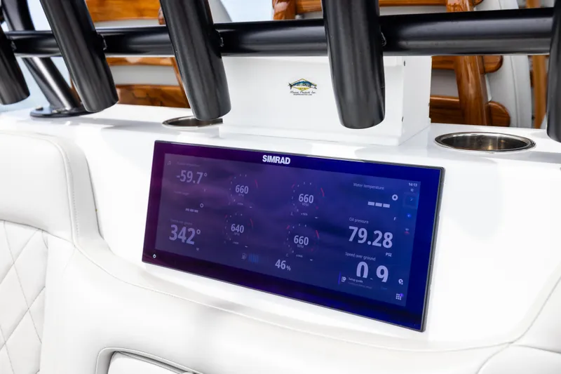 Slide: The Image of Simrad display on 2025 Freeman 42 LR boat dashboard, showing navigation and engine data. - 35