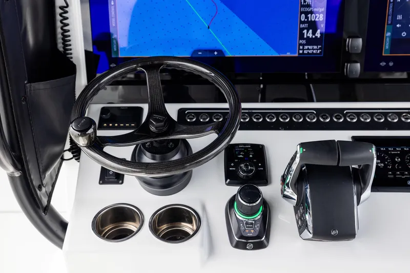 Slide: The Image of Control panel of 2025 Freeman 42 LR boat with steering wheel and navigation display. - 43