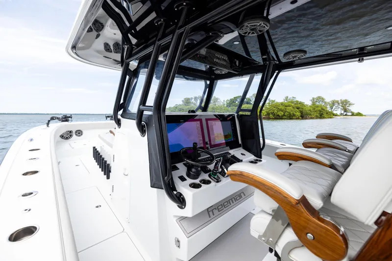 Slide: The Image of 2025 Freeman 42 LR boat interior with advanced navigation system and luxurious seating. - 56