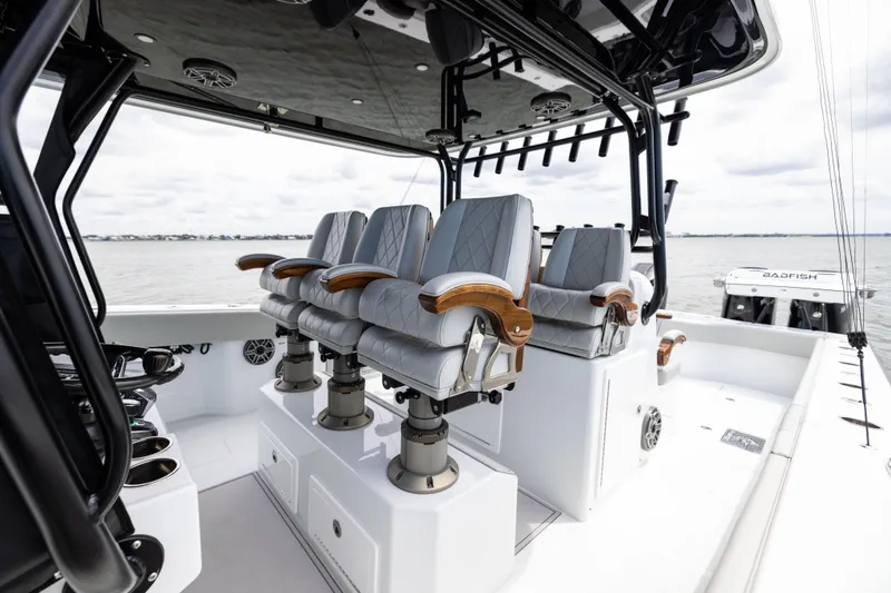 Slide: The Image of Luxury seating on 2025 Freeman 42 LR boat, featuring sleek design and ocean backdrop. - 59