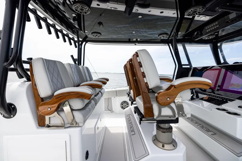 Slide: The Image of Luxury interior of 2025 Freeman 42 LR boat with elegant seating and advanced controls. - 65