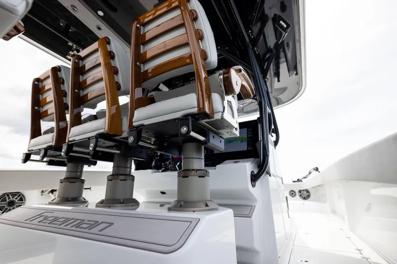 Slide: The Image of 2025 Freeman 42 LR boat interior with elegant wooden seating and modern design. - 66