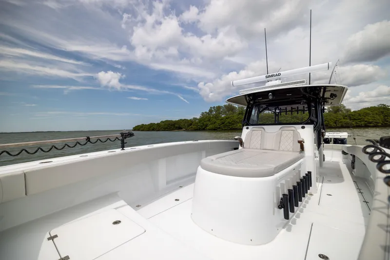 Slide: The Image of Freeman 42 LR 2025 boat with spacious deck and seating, under a partly cloudy sky. - 68