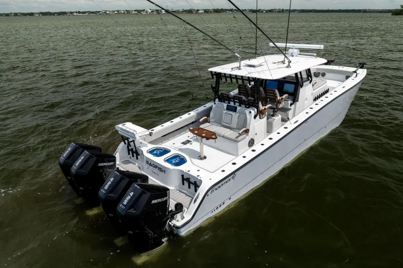 Slide: The Image of 2025 Freeman 42 LR boat with multiple outboard engines on open water. - 7