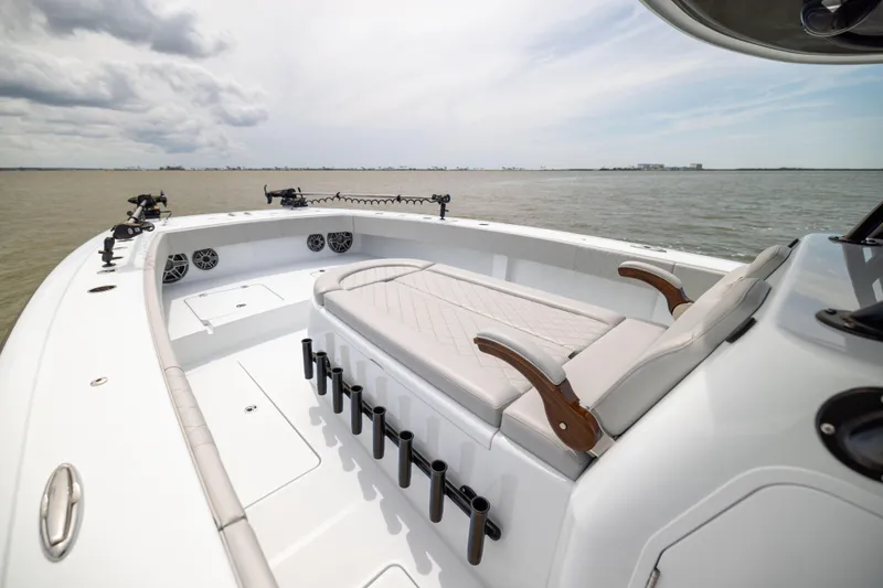Slide: The Image of Luxurious 2025 Freeman 42 LR boat interior with seating, rod holders, and ocean view. - 71