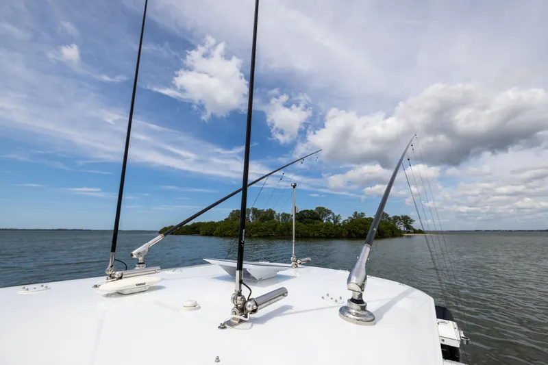 Slide: The Image of Fishing rods on a Freeman 42 LR boat, 2025 model, with scenic water and sky backdrop. - 81