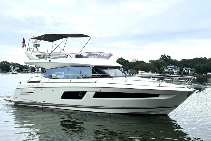 The Image of 2014 Prestige 450 yacht on calm water with scenic background. - 0