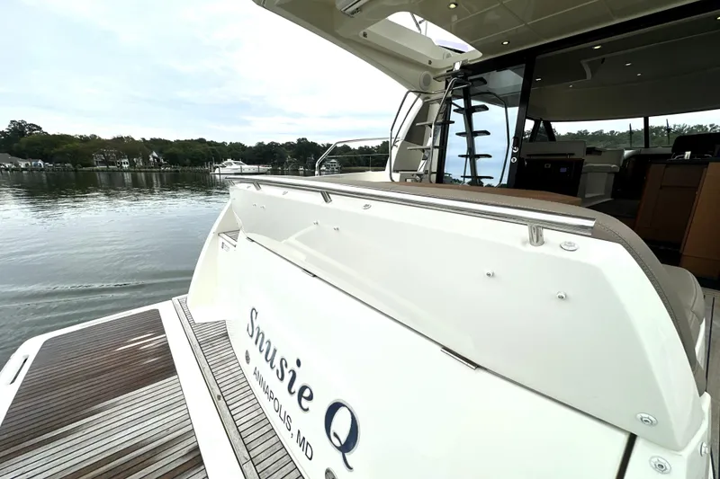 Slide: The Image of 2014 Prestige 450 yacht docked in serene waters, featuring sleek design and spacious deck. - 12