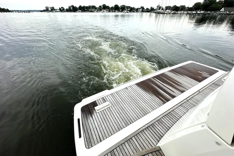 Slide: The Image of 2014 Prestige 450 yacht cruising on calm waters, view from deck. - 13