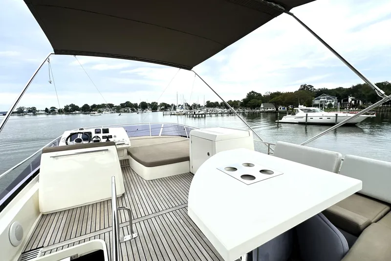 Slide: The Image of Luxurious 2014 Prestige 450 yacht with spacious deck, docked in serene marina setting. - 19