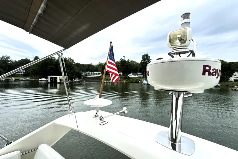 Slide: The Image of Prestige 450 yacht, 2014 model, with American flag on calm waters. - 23