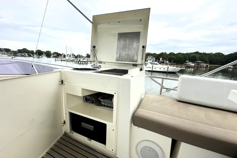 Slide: The Image of Outdoor kitchenette on 2014 Prestige 450 yacht with scenic marina view. - 25