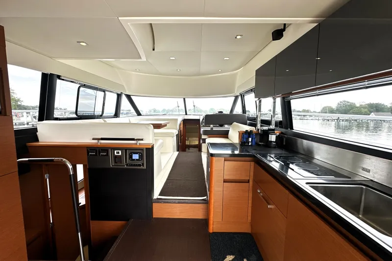 Slide: The Image of Luxurious interior of a 2014 Prestige 450 yacht with modern kitchen and seating area. - 31