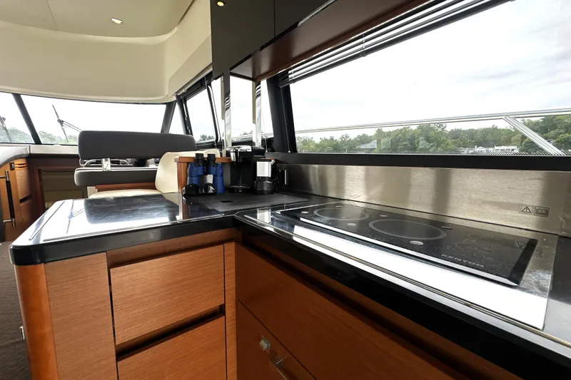 Slide: The Image of Interior of 2014 Prestige 450 yacht with modern kitchen and panoramic windows. - 33