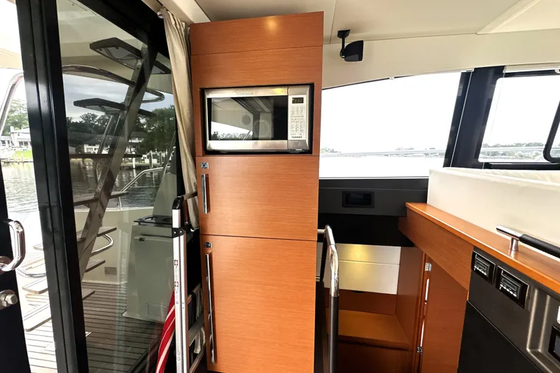 Slide: The Image of Interior of 2014 Prestige 450 yacht with modern kitchen and outdoor view. - 34