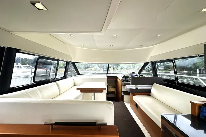 Slide: The Image of Luxurious interior of a 2014 Prestige 450 yacht with spacious seating and panoramic windows. - 37