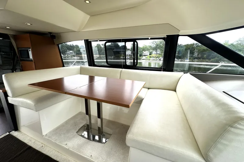 Slide: The Image of Luxurious interior of a 2014 Prestige 450 yacht with elegant seating and dining area. - 40