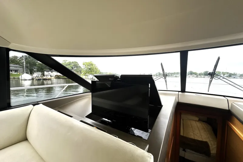 Slide: The Image of Interior view of 2014 Prestige 450 yacht with TV and scenic window view. - 42