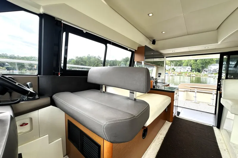 Slide: The Image of Interior of 2014 Prestige 450 yacht with modern seating and scenic water view. - 45