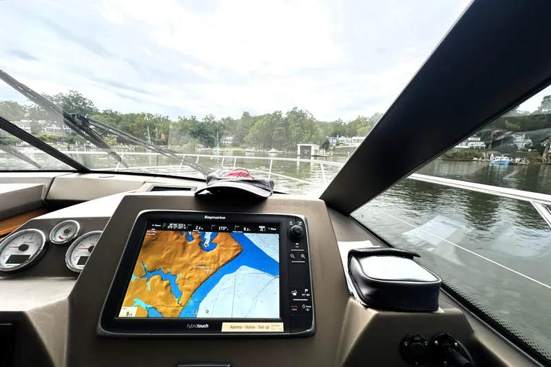Slide: The Image of Cockpit view of 2014 Prestige 450 yacht with navigation system and waterway scenery. - 48