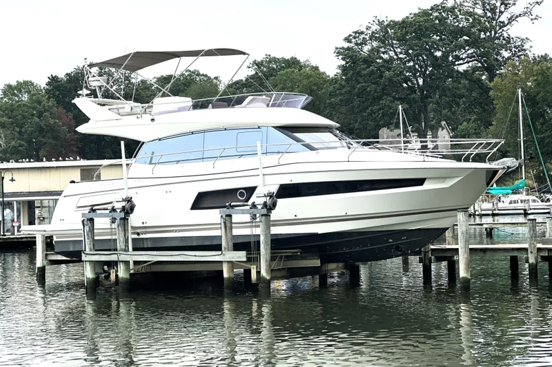 Slide: The Image of Luxury 2014 Prestige 450 yacht docked at marina with scenic background. - 5