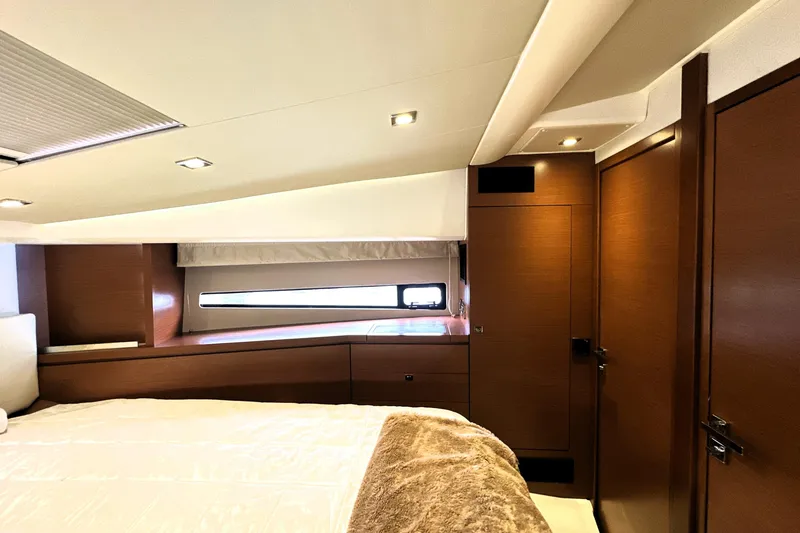 Slide: The Image of Luxurious interior of a 2014 Prestige 450 yacht cabin with modern wood finishes. - 54