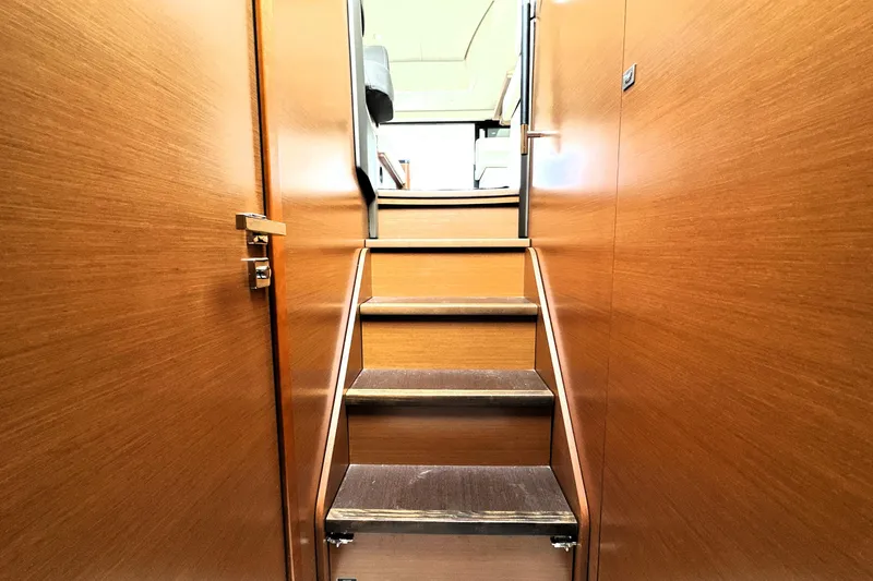 Slide: The Image of Staircase inside 2014 Prestige 450 yacht with wooden paneling and modern design. - 57