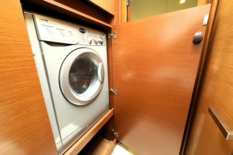 Slide: The Image of Built-in washing machine in wooden cabinet on a 2014 Prestige 450 yacht. - 58