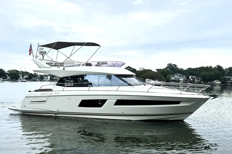 Slide: The Image of 2014 Prestige 450 yacht on calm water, showcasing sleek design and luxury features. - 6