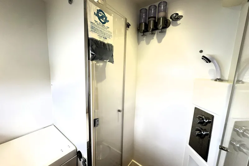 Slide: The Image of Compact bathroom in 2014 Prestige 450 yacht with shower and dispensers. - 67