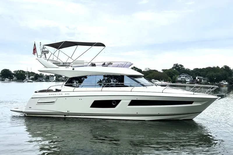 Slide: The Image of 2014 Prestige 450 yacht on calm water, showcasing sleek design and luxury features. - 7