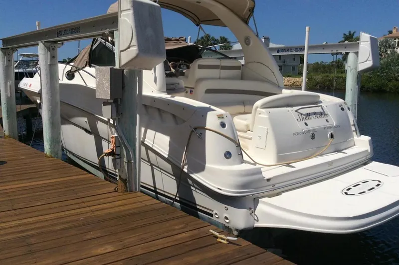 The Image of 2003 Sea Ray 320 Sundancer docked, showcasing sleek design and spacious deck. - 1