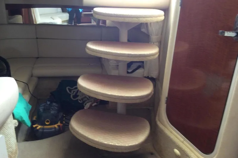 Slide: The Image of Interior of 2003 Sea Ray 320 Sundancer with spiral staircase and seating area. - 11