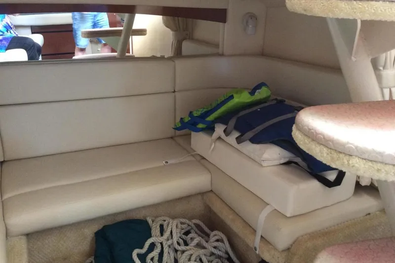Slide: The Image of Interior of 2003 Sea Ray 320 Sundancer with seating, life jackets, and rope storage. - 14
