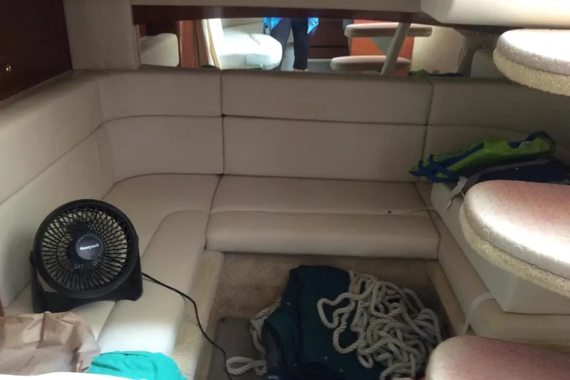 Slide: The Image of Interior of 2003 Sea Ray 320 Sundancer with seating, fan, and nautical equipment. - 15