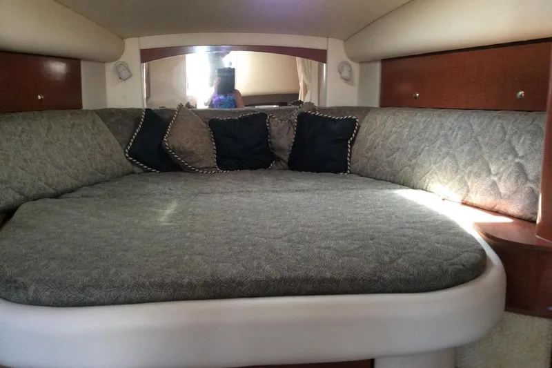 Slide: The Image of Cozy cabin interior of 2003 Sea Ray 320 Sundancer with plush bedding and cushions. - 20