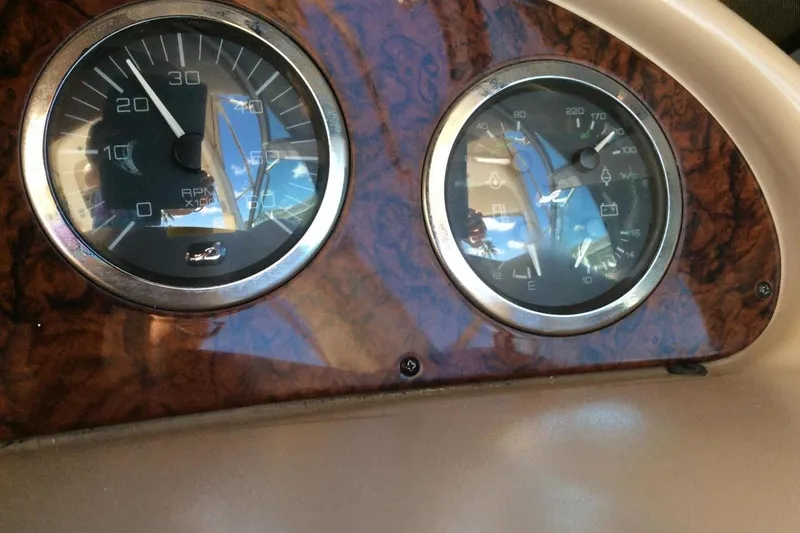 Slide: The Image of Dashboard gauges of a 2003 Sea Ray 320 Sundancer boat. - 23