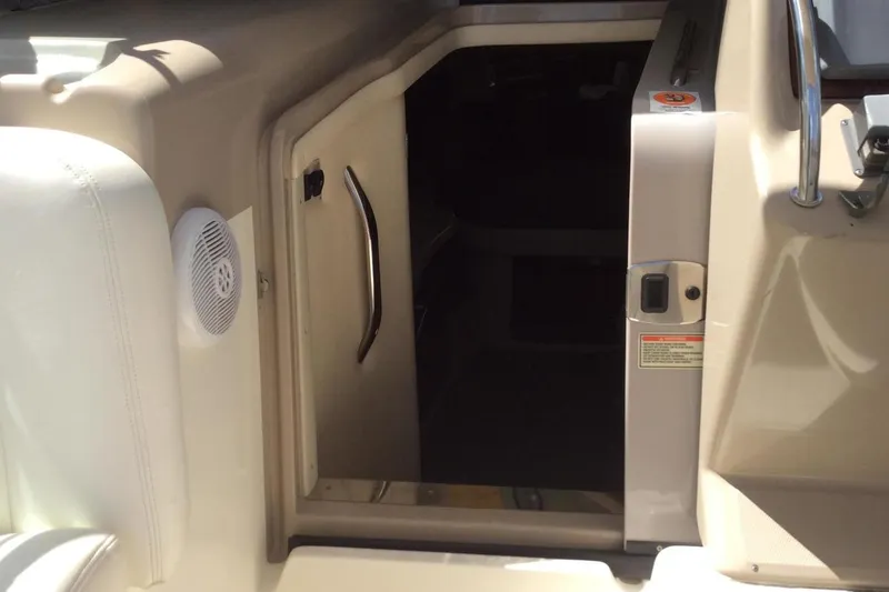 Slide: The Image of Cabin entrance of 2003 Sea Ray 320 Sundancer boat, featuring a sleek handle and speaker. - 27
