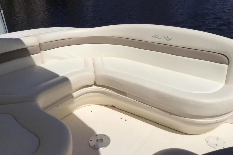 Slide: The Image of 2003 Sea Ray 320 Sundancer boat interior with white cushioned seating. - 28