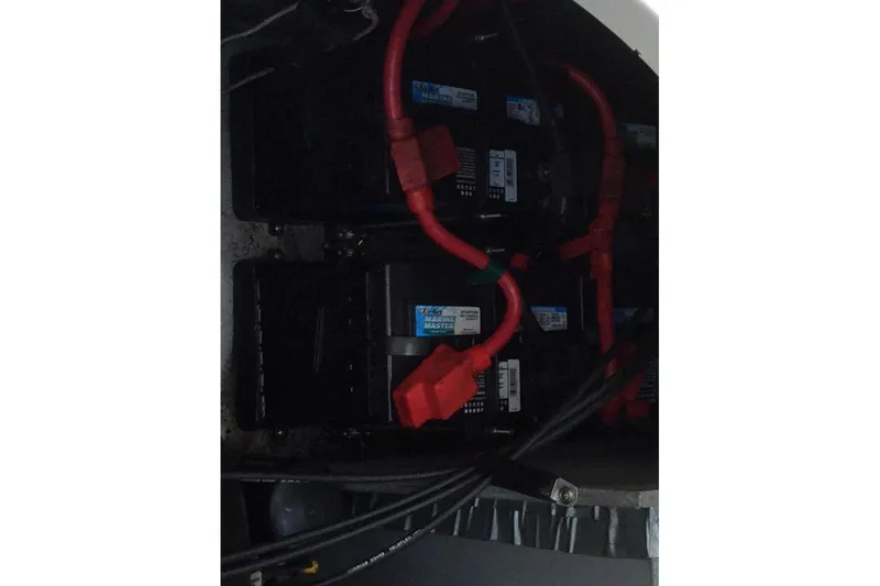 Slide: The Image of Battery compartment of a 2003 Sea Ray 320 Sundancer with red cables. - 4
