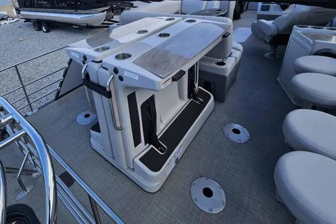 Slide: The Image of 2023 Starcraft CX 23 DL BAR pontoon boat interior with seating and table setup. - 3