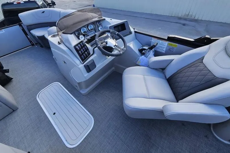 Slide: The Image of 2023 Starcraft CX 23 DL BAR boat interior with modern helm and seating. - 6