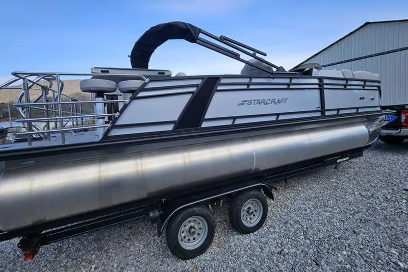 Slide: The Image of 2023 Starcraft CX 23 DL BAR pontoon boat on trailer, parked outdoors. - 7