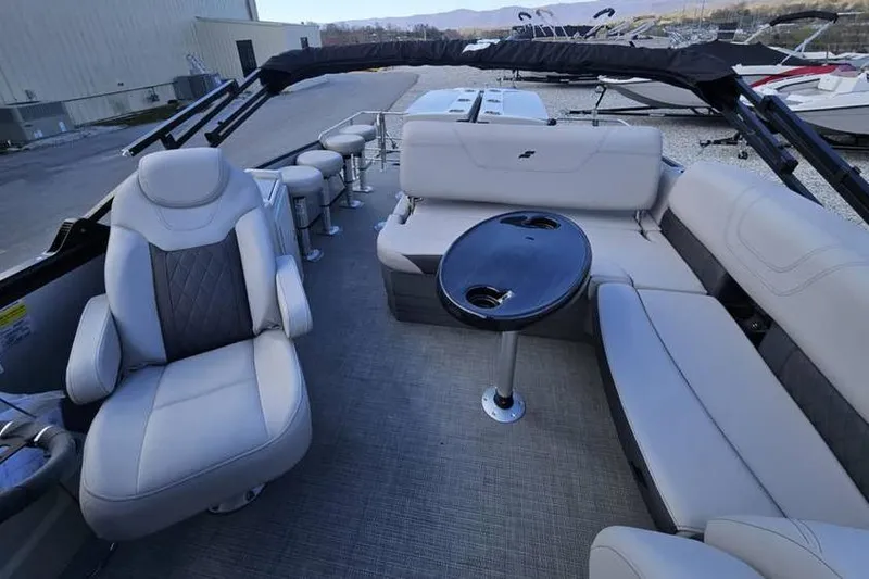 Slide: The Image of 2023 Starcraft CX 23 DL BAR pontoon boat interior with plush seating and table. - 8