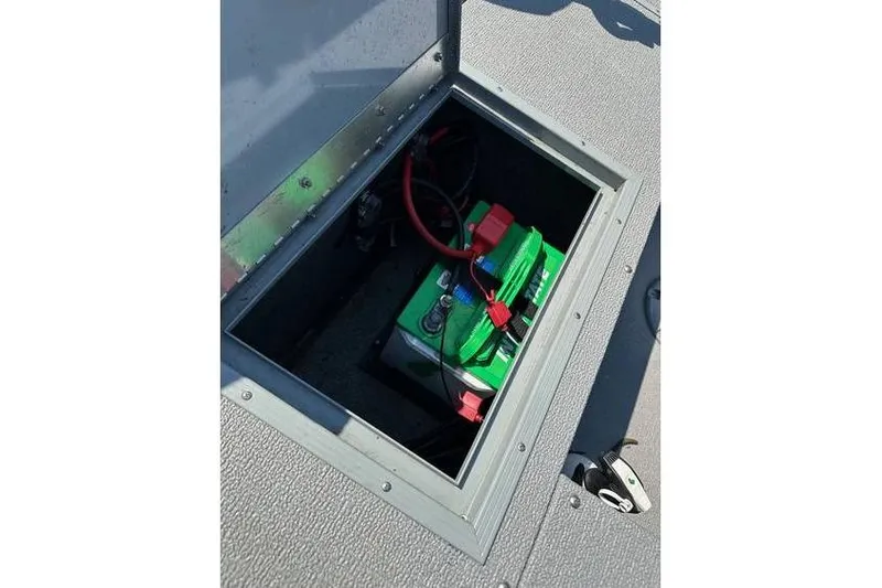 Slide: The Image of Battery compartment of 2021 Starcraft Delta 168 Tiller boat with visible wiring. - 12