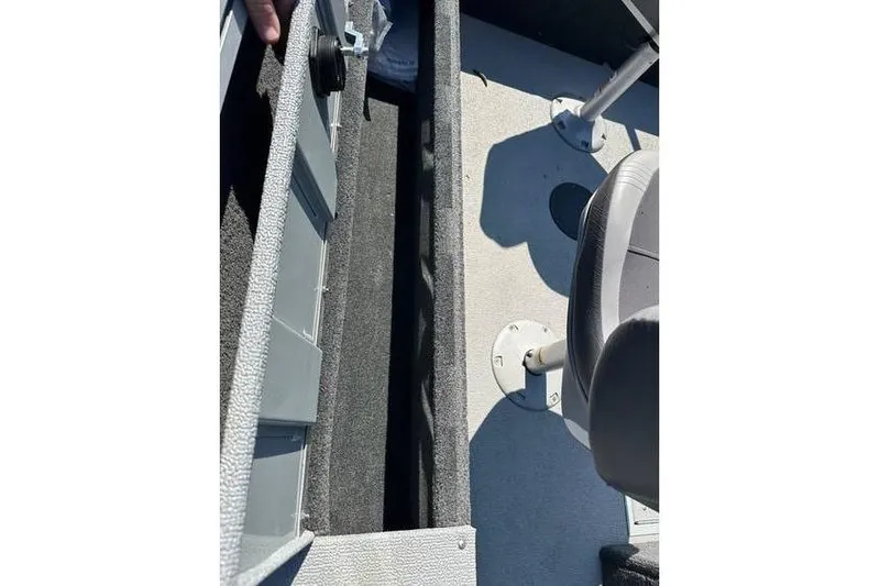 Slide: The Image of Interior view of 2021 Starcraft Delta 168 Tiller boat, showing seating and storage compartment. - 13